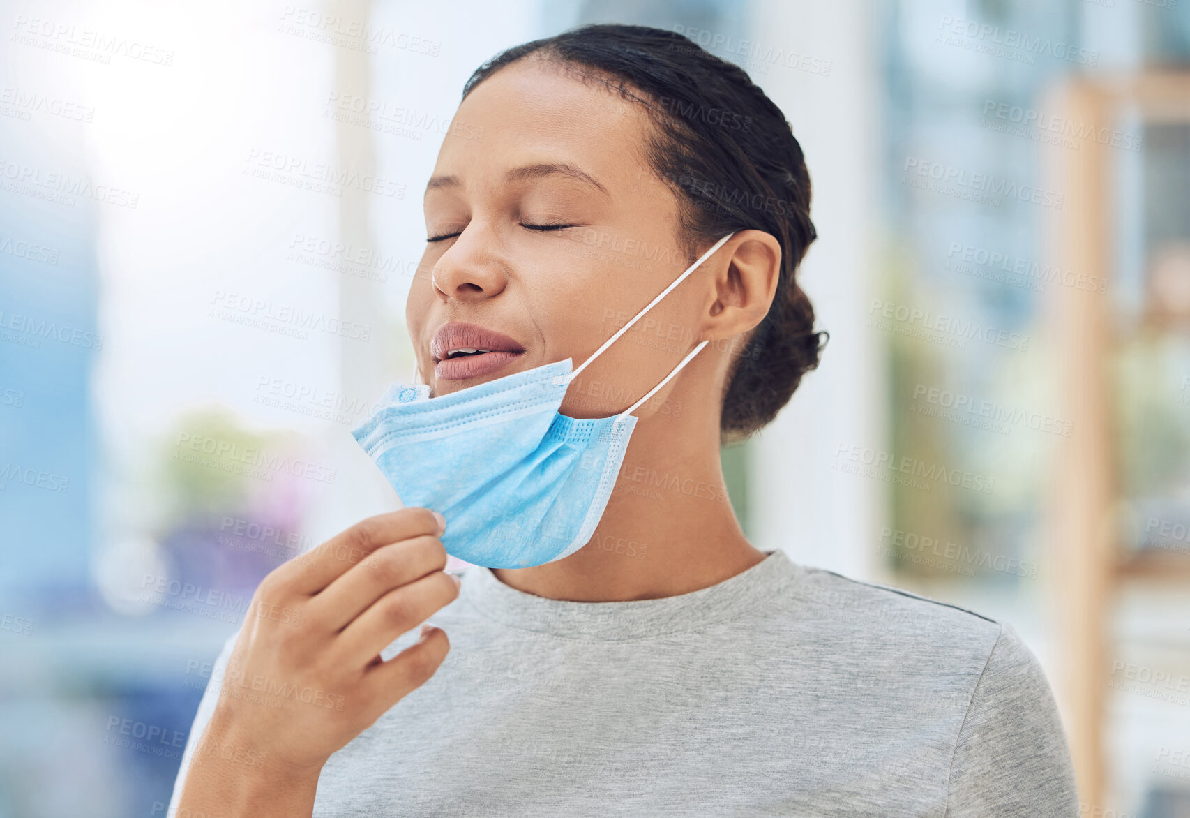 Buy stock photo Woman, relax and breathing with face mask in office for healthcare compliance, medical safety or peace of health. Female person, relief or security protocol for virus risk, fresh air and danger rules