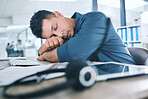 One hispanic call centre telemarketing agent sleeping in an office. Businessman feeling overworked, tired and demotivated while operating helpdesk. Lazy consultant slacking and ignoring customers by taking a nap. Burnout and stress in the workplace