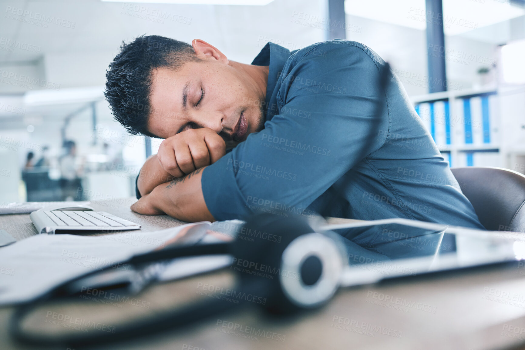 Buy stock photo Tired, man and desk in call center for sleep, exhausted and burnout in telemarketing. Male agent, tech and burnout in office with insomnia, depression and overwhelmed by stress with fatigue and rest