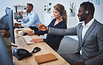 Happy caucasian female call centre telemarketing agent discussing plans with african american colleague while working together on computer in an office. Consultants troubleshooting solution for customer service and sales support