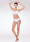 Portrait of a beautiful young mixed race model posing seductively in underwear against a grey studio copyspace background. Confident hispanic woman showing her curvy shape and smooth hairless skin