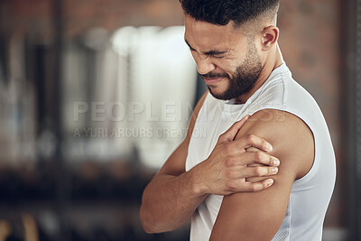 Buy stock photo Frustrated man, fitness and arm injury with muscle tension from pain, accident or inflammation at gym. Male person with sore shoulder, joint or sprain in discomfort from workout or indoor exercise