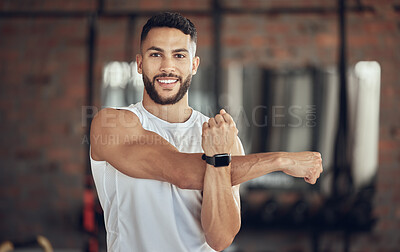 Buy stock photo Man, portrait and stretching arm in gym for warm up, daily workout routine and fitness for muscle development. Male person, happy and flexing for physical cardio, training or exercise for health.