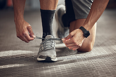 Buy stock photo Man, fitness and tie shoes with laces at gym in preparation for running, workout or exercise. Closeup of male person, runner or athlete tying sneakers and getting ready for training at health club