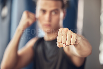 Buy stock photo Man, boxer and fitness with fist for training, self defense or workout in martial arts at indoor gym. Active male person or young fighter with punch for practice, exercise or cardio at health club