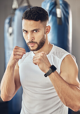 Buy stock photo Man, portrait and fist for fitness in gym for fighting tournament, boxing match and training for competition. Male person, serious and ready for challenge or sport, self defense and mma performance.