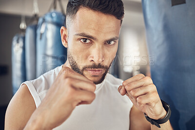 Buy stock photo Man, portrait and fist for workout in gym for fighting tournament, match or training for competition. Male person, serious and ready for challenge or sport, self defense and mma performance or boxing