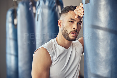 Buy stock photo Tired man, portrait and boxer with punching bag for self defense training, practice or martial arts at gym. Exhausted male person or fighter in fitness for break after intense exercise or boxing