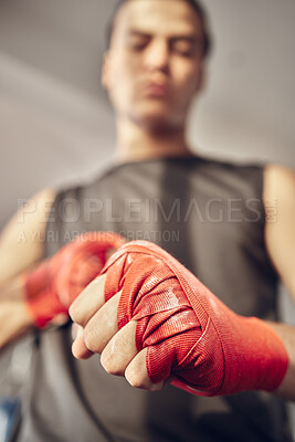 Buy stock photo Man, boxer and fist with bandage for self defense training, martial arts or boxing match at indoor gym. Closeup of male person, athlete or fighter wrapping hands or knuckles for combat or battle