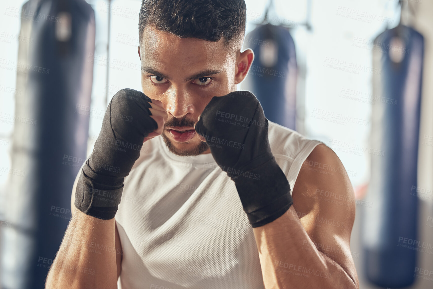 Buy stock photo Man, portrait and fist for training in gym for fighting tournament, boxing match and fitness for competition. Male person, serious and ready for challenge or sport, self defense and mma performance.