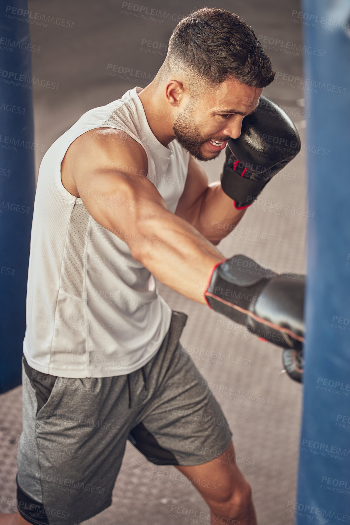 Buy stock photo Man, fighter and punching bag with boxing gloves for training, combat practice or self defense at gym. Male person, athlete or boxer with strike or attack in fitness for martial arts at health club