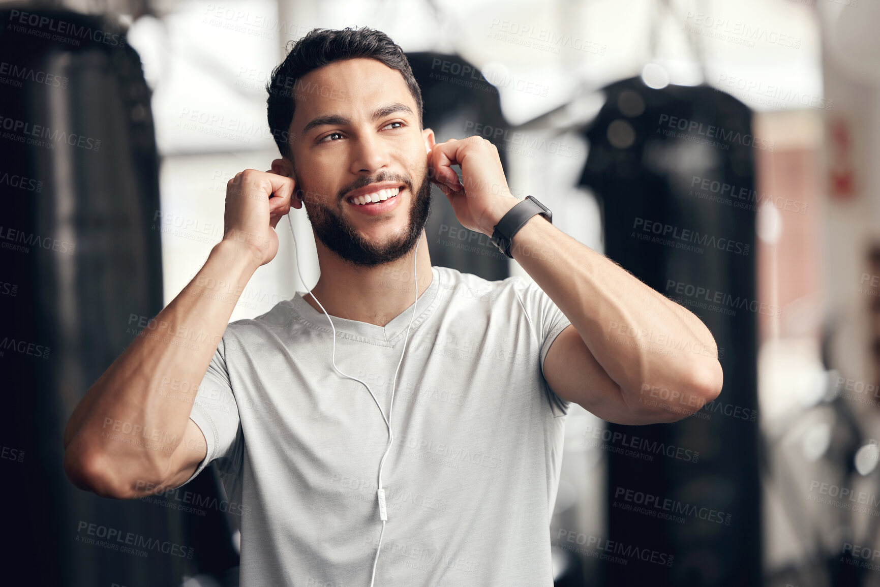 Buy stock photo Portrait, earphones and man in gym, fitness and music for training, exercise and thinking in morning. Calm, athlete and person with audio for workout, happy and streaming of sound with tech and app