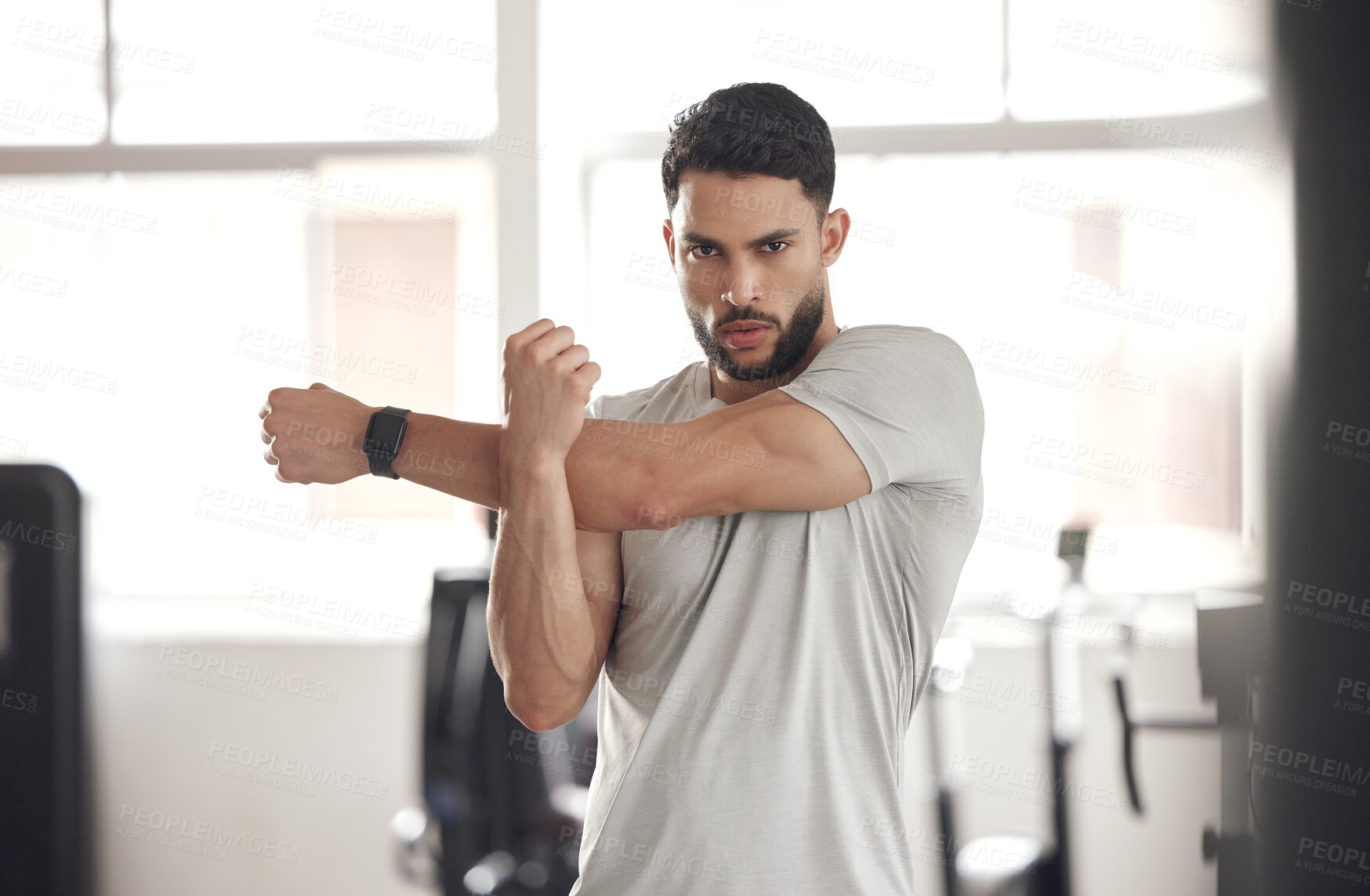 Buy stock photo Portrait, stretching and man with fitness, workout and commitment to routine, exercise goals and serious. Face, person and athlete with warm up, wellness center and sports with practice and training