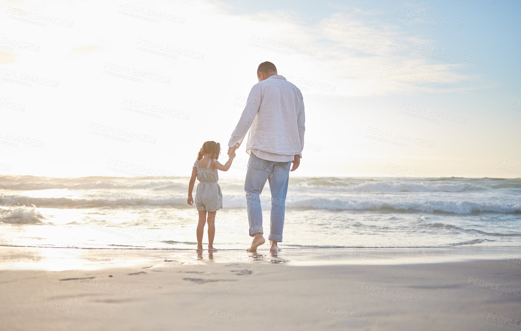 Buy stock photo Dad, girl and holding hands with back on beach for bonding adventure, ocean view and summer vacation for family time. Father, daughter and together by sea with love or support, holiday and journey.