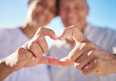 Buy stock photo Heart, closeup and couple with hands for care, love and connection together on holiday outdoor. Fingers, man and woman with romance sign, support or loyalty for relationship commitment or trust emoji