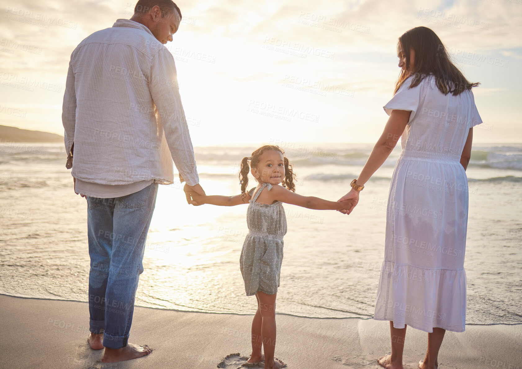 Buy stock photo Parents, girl and holding hands with love on beach for childhood support, summer vacation and family time. Father, mother and daughter by ocean on holiday for bonding, weekend trip and adventure.