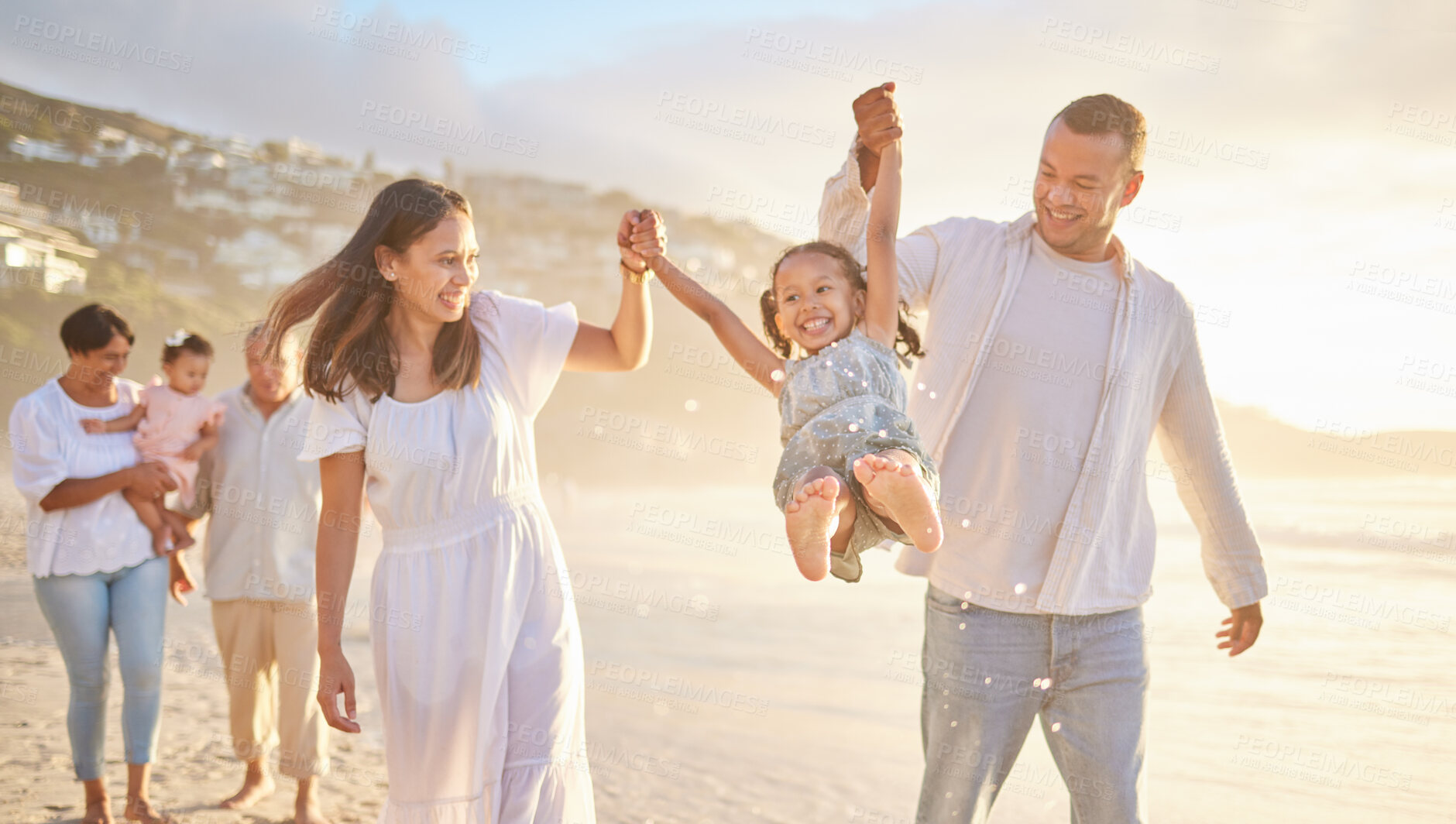 Buy stock photo Beach, family and parents lifting kid on vacation, adventure or getaway together for bonding by sea. Happy, generations and children with grandparents and mom and dad for fun by ocean on holiday.
