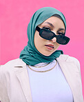 Beautiful young arab woman posing outdoors in a headscarf. Attractive female muslim wearing a hijab posing outside. She's all about style and fashion. Mixed race woman looking confident and trendy