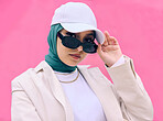 Beautiful young arab woman posing outdoors in a headscarf. Attractive female muslim wearing a hijab posing outside. She's all about style and fashion. Mixed race woman looking confident and trendy