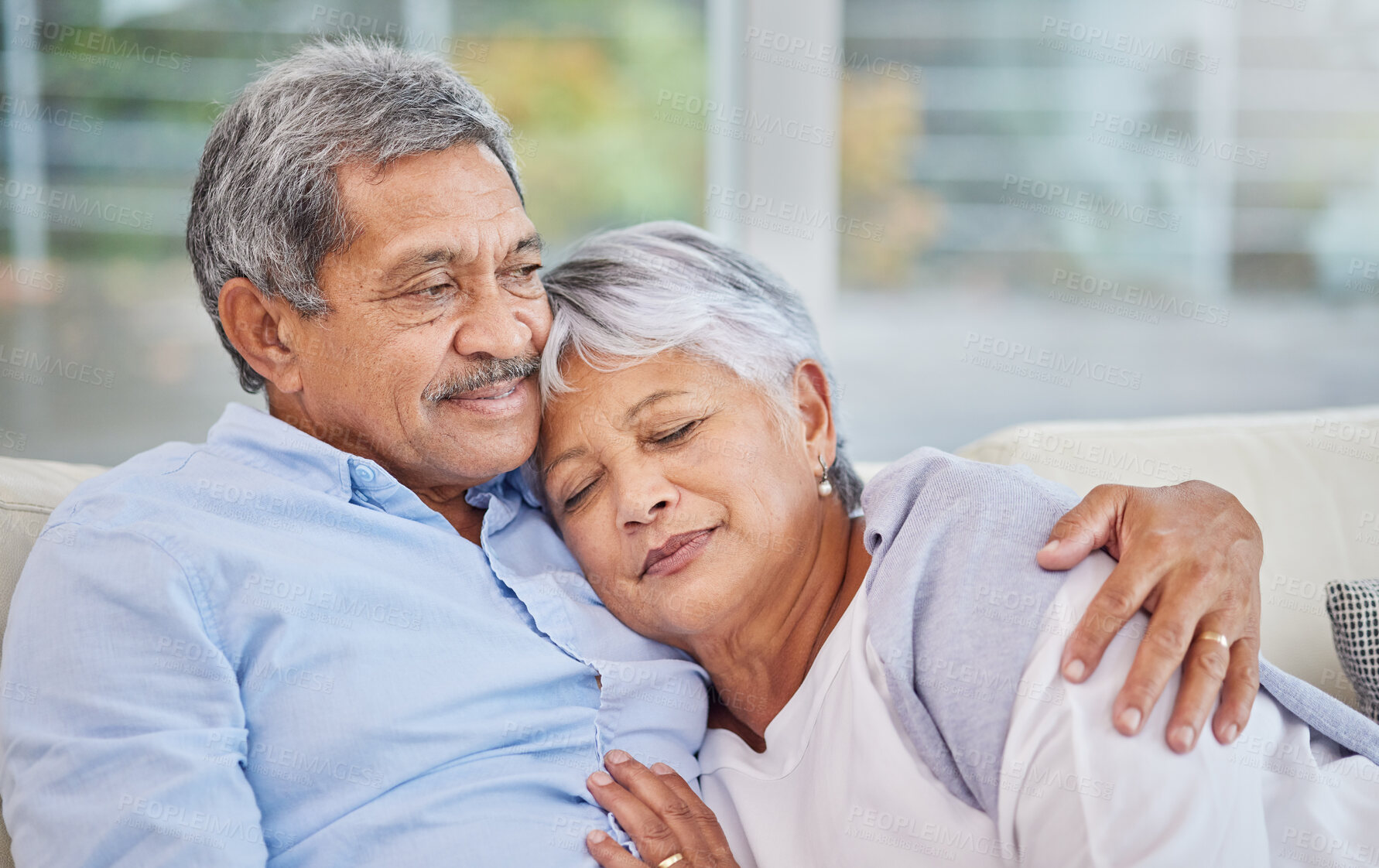 Buy stock photo Hug, love and security with senior couple on sofa of home living room together for bonding. Marriage, relax or wellness with elderly man and woman in apartment for relationship, retirement or romance