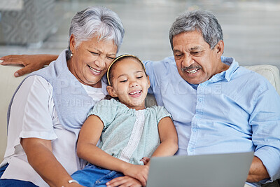 Buy stock photo Laptop, child and senior couple on sofa for movie streaming, internet subscription and tech family bonding in home. Grandparents, girl and funny online video on couch with people laughing together