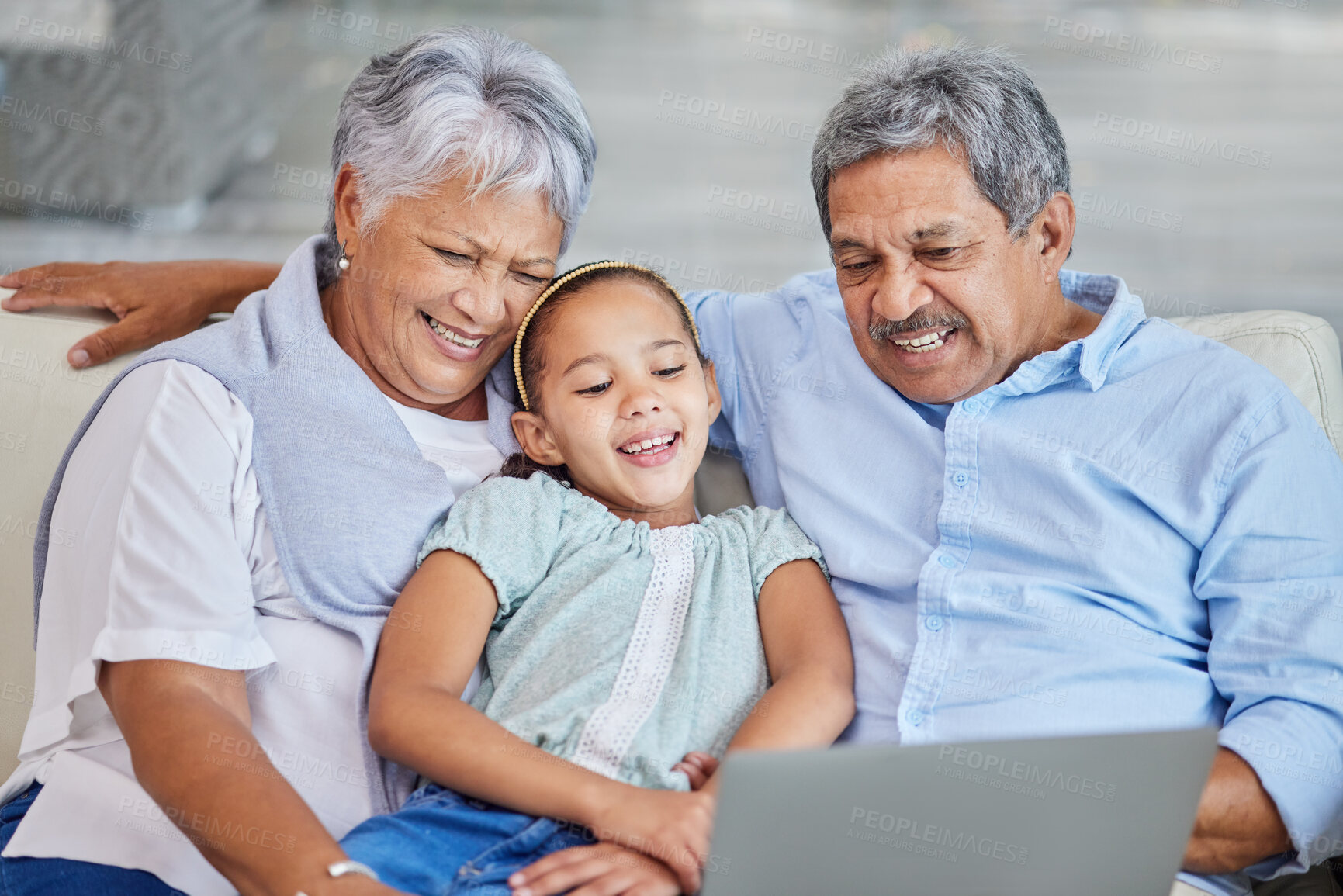 Buy stock photo Laptop, child and senior couple on sofa for movie streaming, internet subscription and tech family bonding in home. Grandparents, girl and funny online video on couch with people laughing together