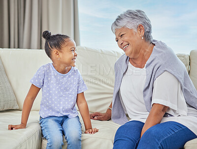 Buy stock photo Grandmother, girl and happy or laughing in home on sofa for love, support and bonding as babysitter. People, family and smile for visit on couch in living room with kid for fun, care and relax