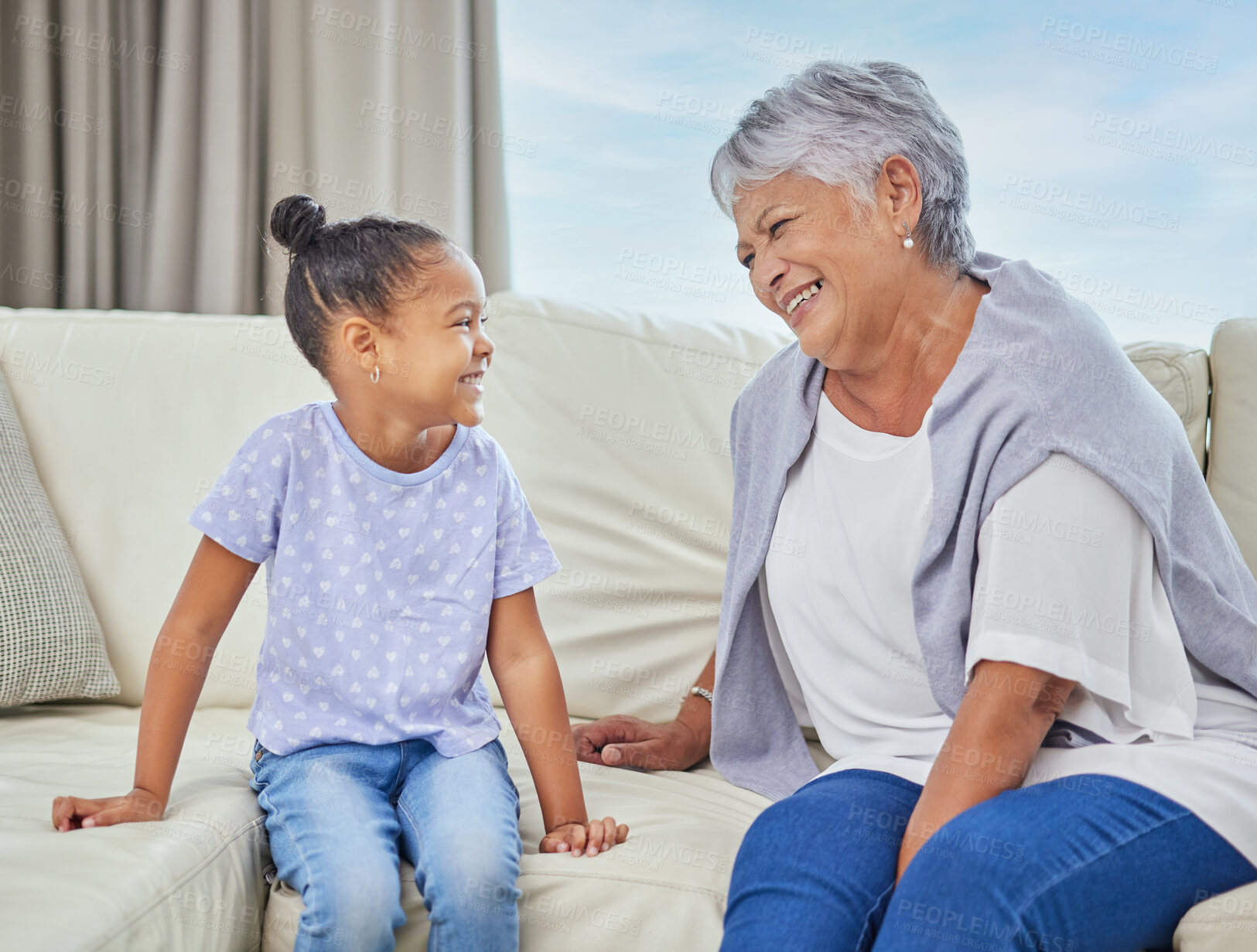 Buy stock photo Grandmother, girl and happy or laughing in home on sofa for love, support and bonding as babysitter. People, family and smile for visit on couch in living room with kid for fun, care and relax