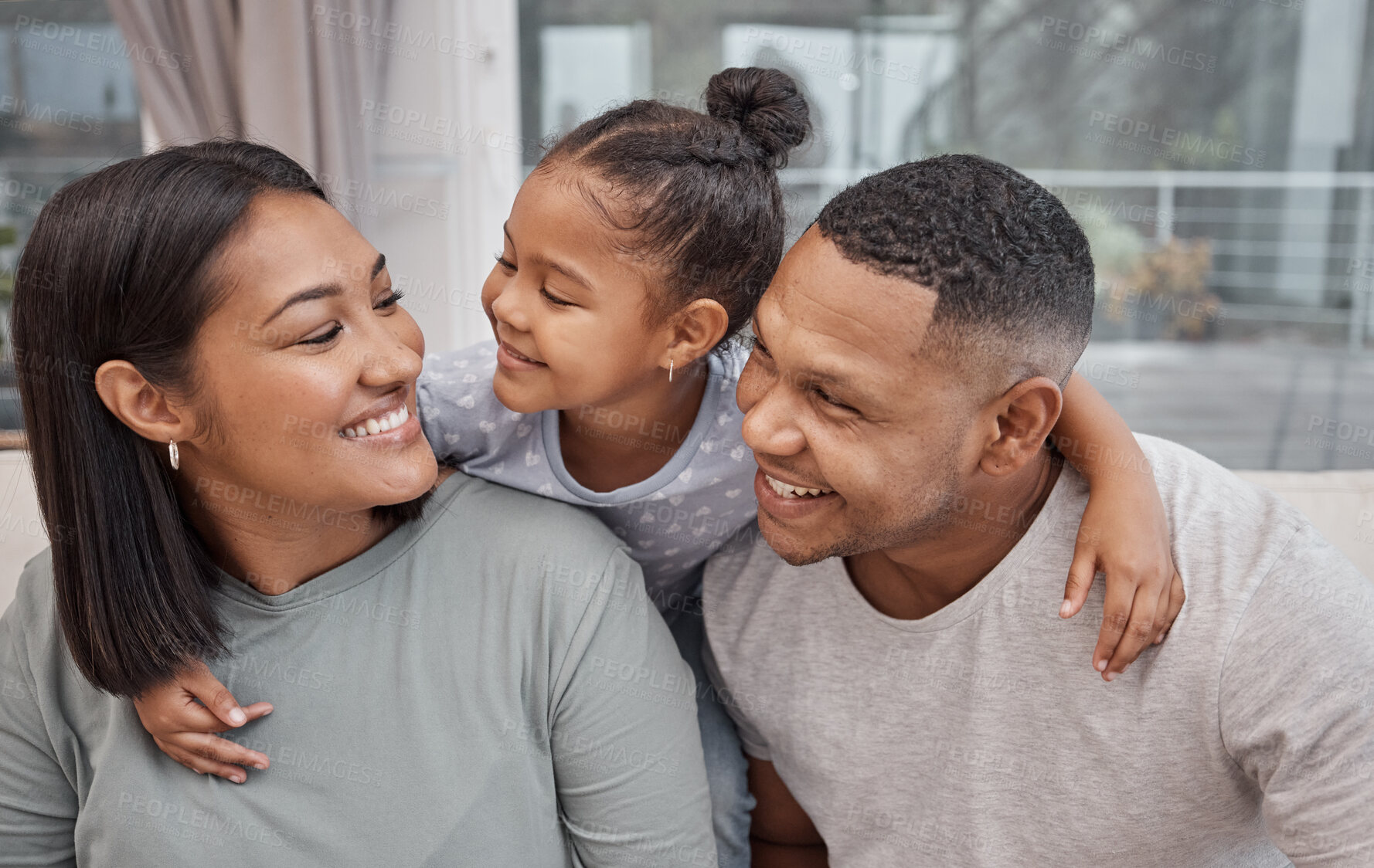 Buy stock photo Hug, love or smile with family on sofa in living room of home together for bonding or support. Funny, happy or laughing with daughter, father and mother in apartment lounge for comedy or security