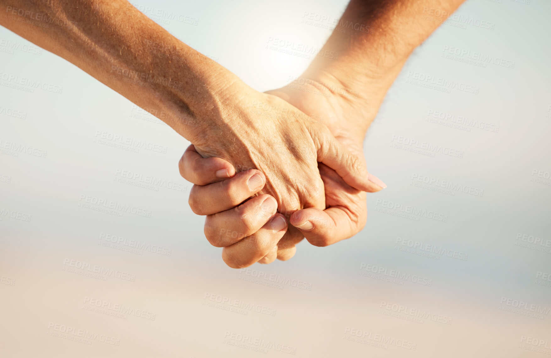 Buy stock photo Couple, hands and holding for love in outdoor, security and marriage commitment for connection. People, trust and support in relationship on beach date, together and lovers affection on weekend trip