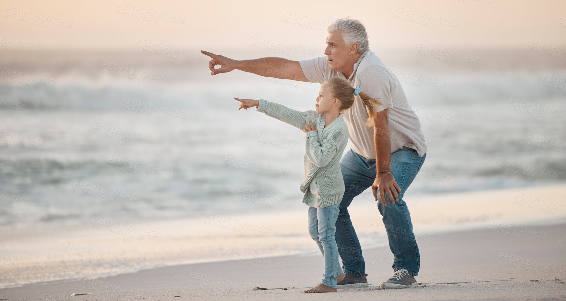 Buy stock photo Grandfather, girl and pointing at beach for travel, bonding and sunset while on vacation together. Family, generations and fun outdoor by sea for dusk, relationship and adventure on tropical holiday