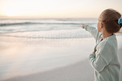 Buy stock photo Girl, child and beach at sunset with point, direction or outdoor on vacation for memory in summer. Kid, holiday and horizon by ocean, sea and sunshine at dusk for adventure, play or learning in Spain