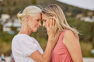 Buy stock photo Beach, hug and senior mother with woman on holiday, vacation and weekend together. Family, forehead touch and mature mom with daughter embrace by ocean for bonding, relationship and affection