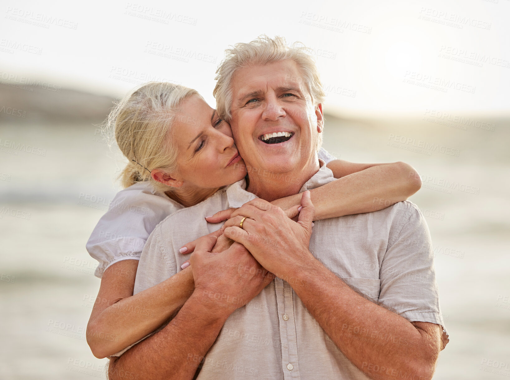 Buy stock photo Love, beach and senior couple kiss at water for bonding holiday, embrace and island travel. Nature, man and woman on romantic ocean date together with smile, hug or happy tropical retirement vacation