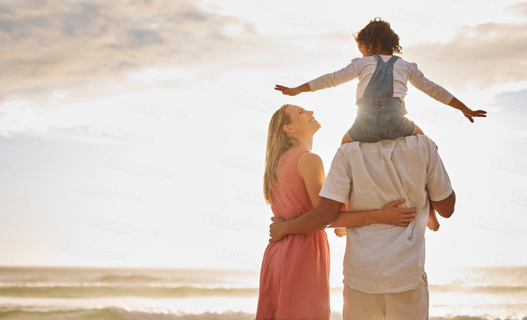 Buy stock photo Back, child and parents on beach as happy family for love, support and care on vacation or holiday. Woman, male person and bonding with kid on shoulders in outdoor for together, affection and relax