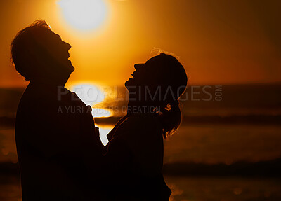 Buy stock photo Laugh, beach and silhouette of couple at sunset for bonding holiday, love and tropical island travel. Nature, man and woman on romantic ocean date together with hug, orange sky and outdoor vacation