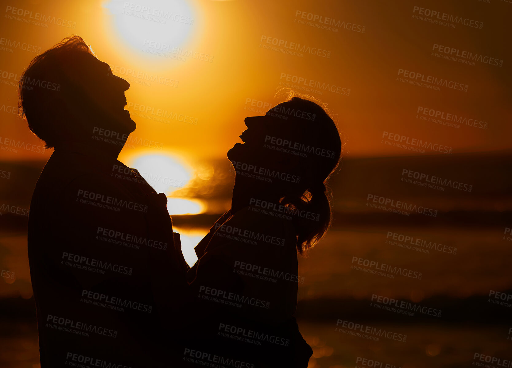 Buy stock photo Laugh, beach and silhouette of couple at sunset for bonding holiday, love and tropical island travel. Nature, man and woman on romantic ocean date together with hug, orange sky and outdoor vacation