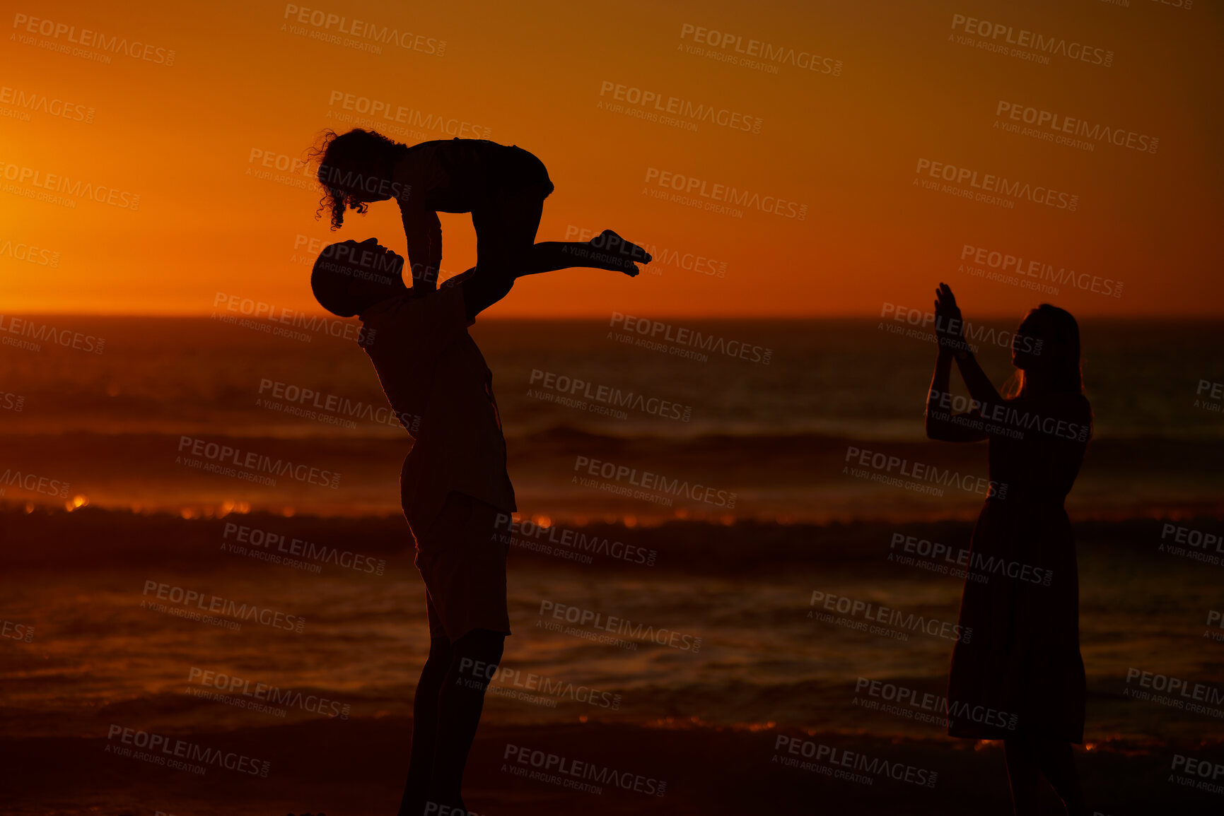 Buy stock photo Sunset, parents and kid with lifting at beach for bonding on break, relax and fun in Spain. People, family and playful on silhouette at ocean on holiday with happiness for child development or growth