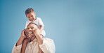 Smiling mixed race father carrying little son on his shoulders on a beach with copyspace. Adorable, happy, hispanic boy bonding with single parent outside on weekend. Man and child enjoying free time