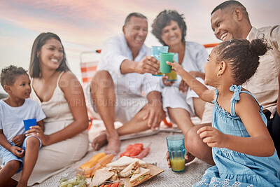 Buy stock photo Happy family, beach and toast with drink at picnic for holiday, summer and lunch. Juice, cheers or people by coast with food for generations, parents or kids with grandparents at celebration to relax