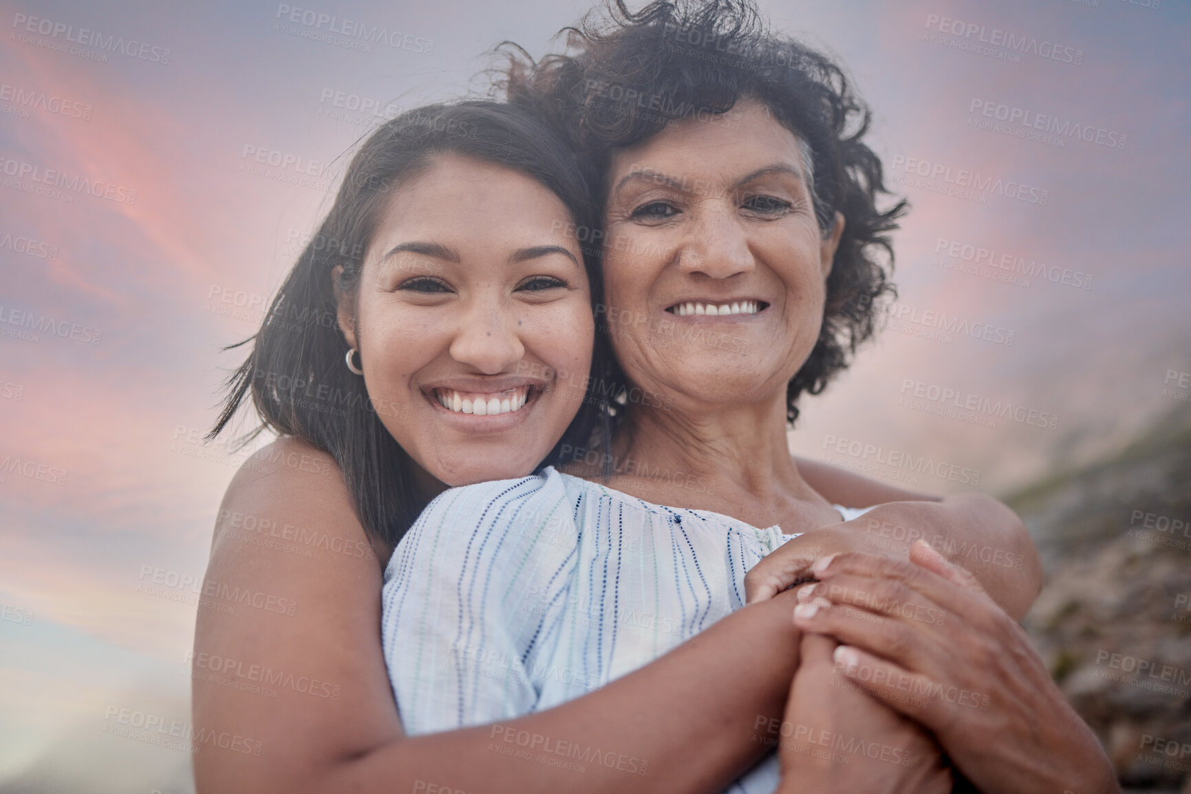 Buy stock photo Beach, hug and portrait of mother with daughter outdoor at sunset for holiday, travel or vacation together. Face, love or smile with senior parent and woman embracing on coast for bonding or getaway