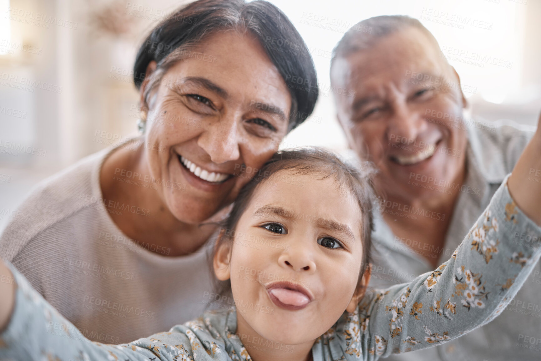 Buy stock photo Selfie, goofy and portrait of child with grandparents in home for memory, bonding or family time. Smile, love and face of girl kid with grandmother and grandfather for photography picture in house.