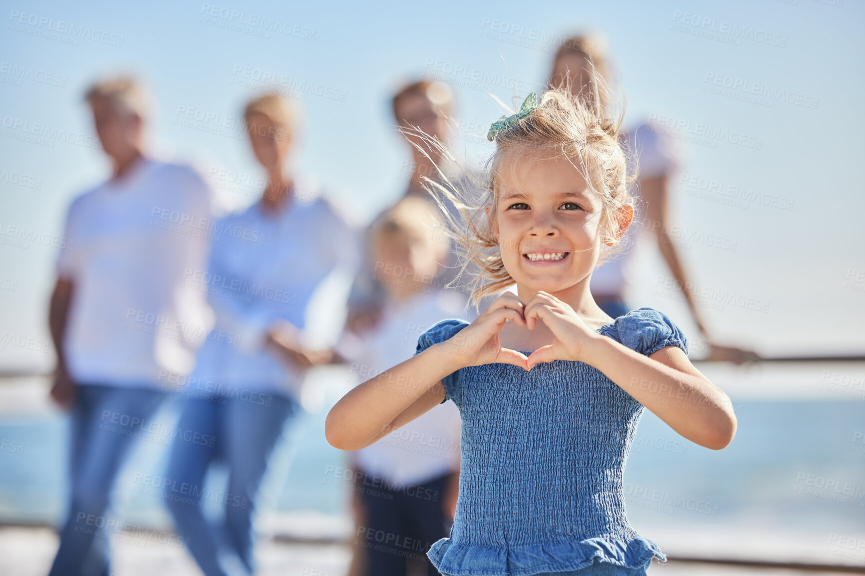 Buy stock photo Portrait, girl and heart hand for summer holiday, family vacation and travel adventure. Happy child, ocean and love emoji with smile, joy and seaside tourism for childhood bonding and outdoors fun