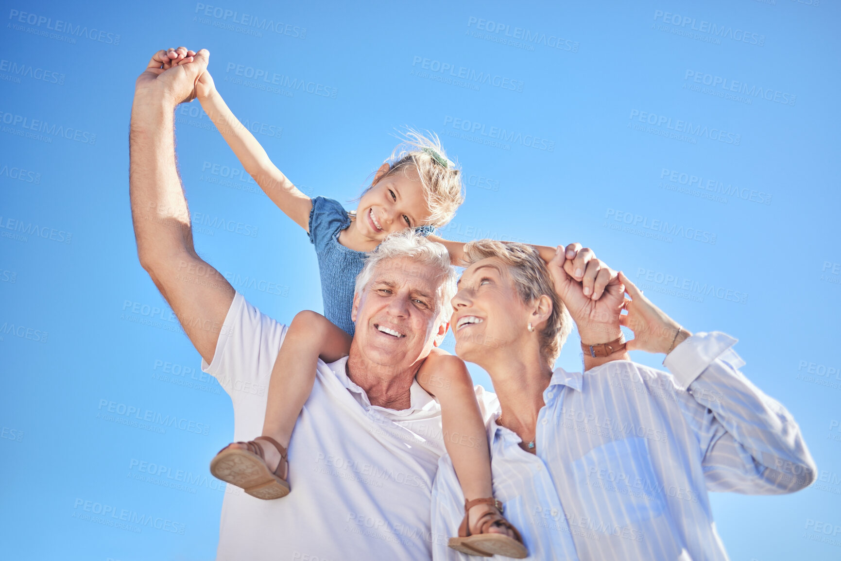 Buy stock photo Portrait, girl and grandparents for summer vacation, family holiday and travel adventure. Happy child, blue sky and shoulder ride with smile, joy and tourism for childhood bonding and outdoors fun