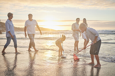 Buy stock photo Family, beach and fish net game with parents and kids together with grandparents outdoor. Sunset, travel and love of generations with smile, happy youth and support on holiday by the sea in Florida