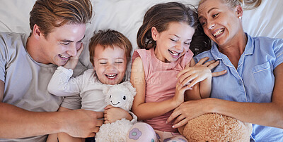 Buy stock photo Above, family and laugh with embrace in bedroom for  bonding and support of funny game as joke. Happy, parents and girl with teddy bear, hug and relax together for morning care at house of childhood