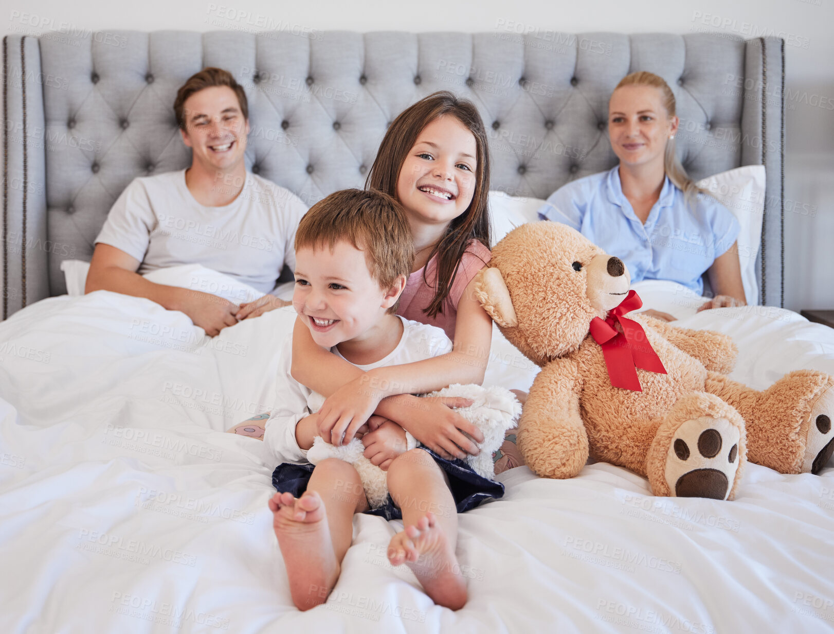 Buy stock photo Portrait, children and smile with embrace in bedroom for love, bonding and siblings support of childhood memory. Happy, kids and parents for hug, teddy bear and relax together in morning at house