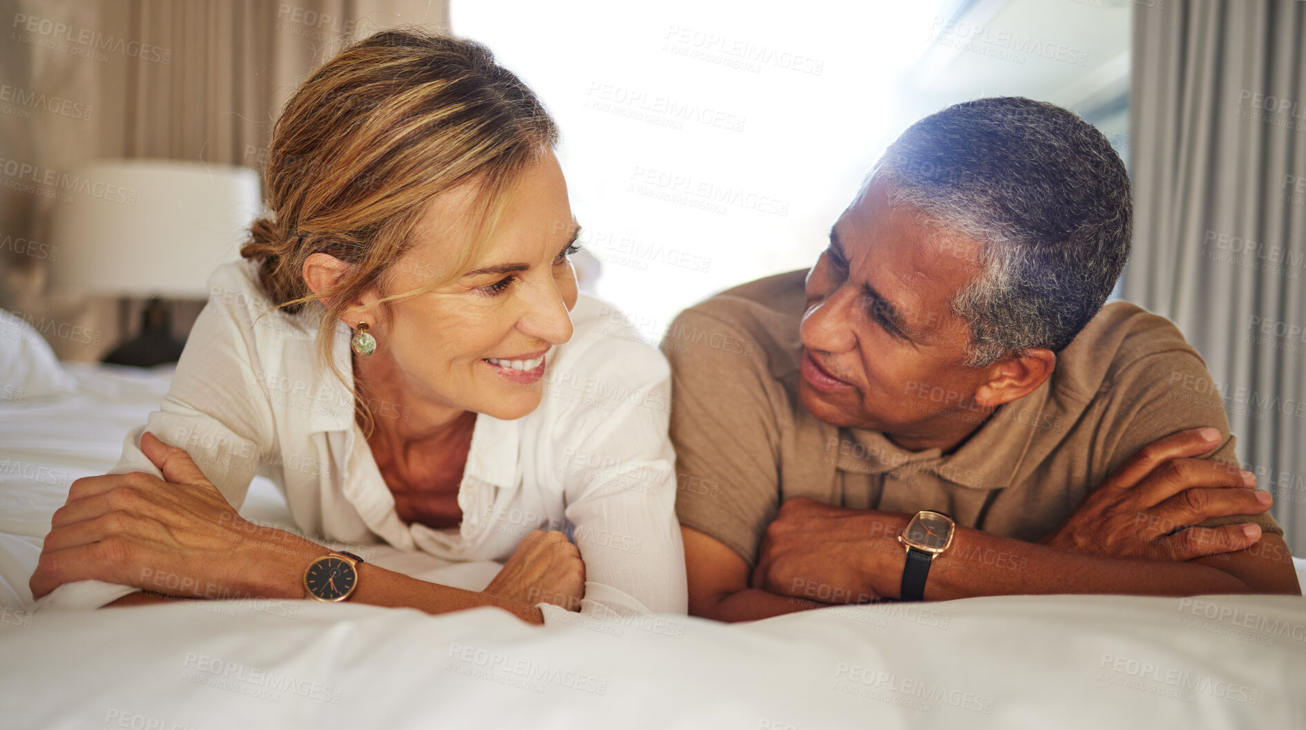 Buy stock photo Love, smile or mature couple on bed for relax, bonding or talking with support at hotel. Lovers, happy or trust in bedroom with good communication, relationship development or vacation for milestone