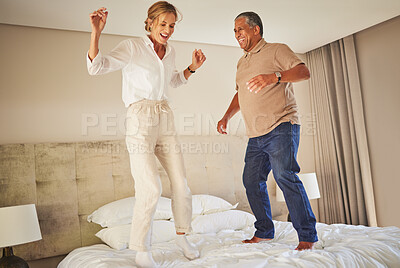 Buy stock photo Mature couple, happy and jump on bed in hotel with energy, fun and excited for milestone. Vacation, dance and people in love with celebration, good mood and fun in morning and comfort in relationship