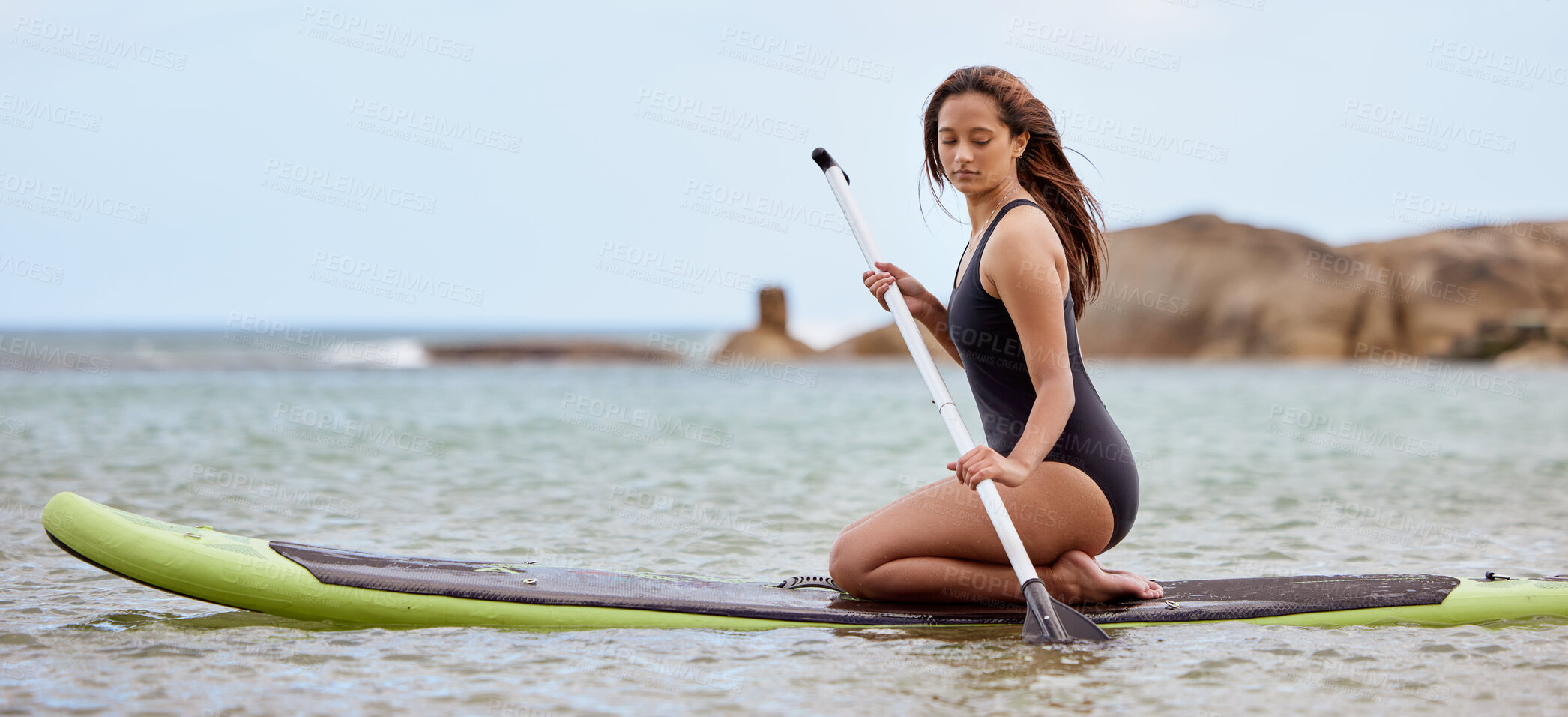 Buy stock photo Surfer, fitness and woman in ocean with surfboard and paddle, swimwear and focus with sport outdoor and nature. Beach, exercise and young female surfing, waves and adventure with extreme sports